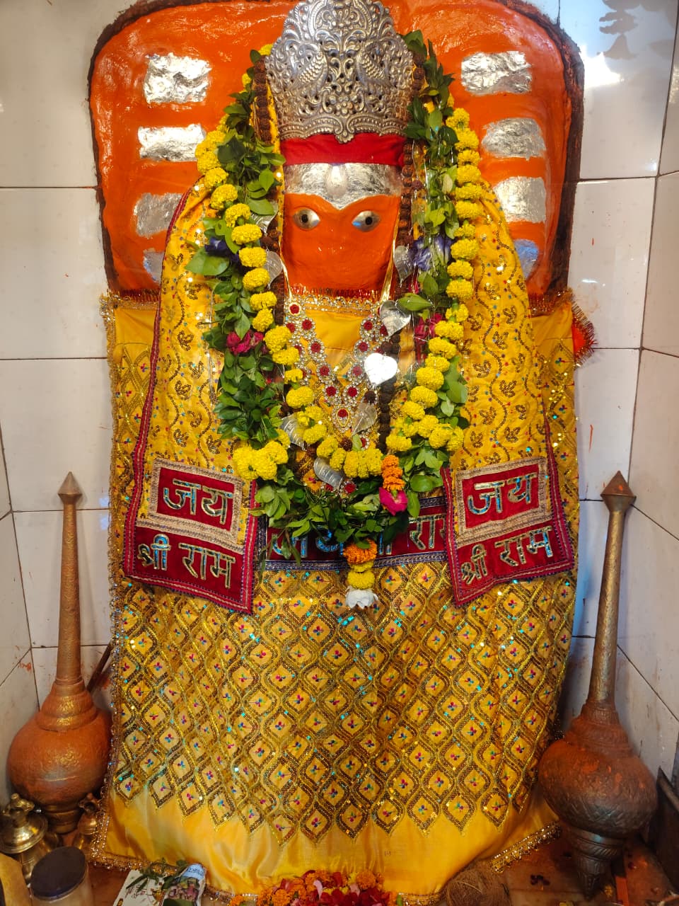 Divine murti of Sote Wale Baba adorned with yellow garments and garlands